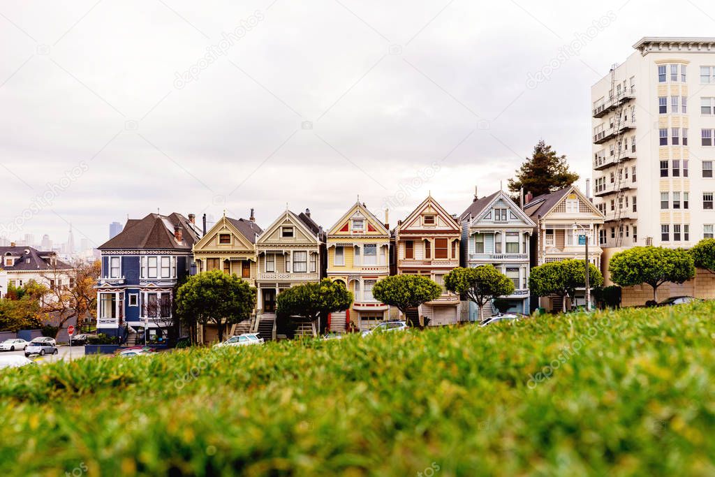 Morning picture of San Francisco most attractive symbol - Painted Ladies buildings at Alamo Square Park.