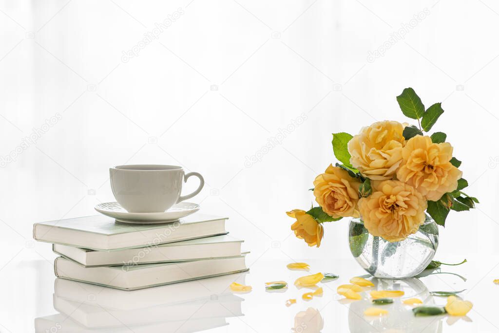 A cup of coffee. Good morning. Tea time. Cup with coffee on the books. Good morning with a book and coffee. Relax. Hugge.