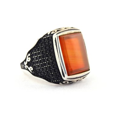 Taş, beyaz arka planda insanların gümüş yüzüklerini işledi.