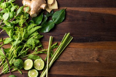 Çeşitli taze Asya otları ahşap masadaki yiyecekler.