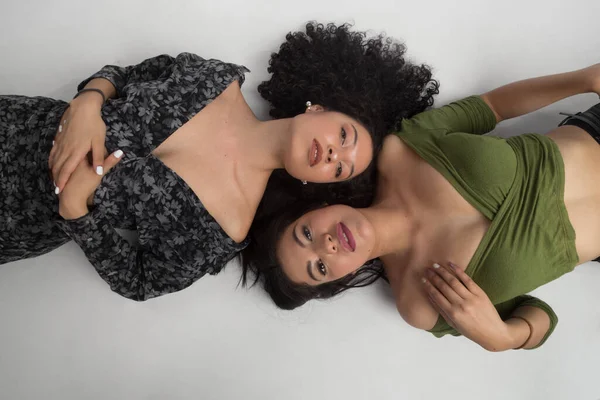 Dos Mujeres Morenas Jóvenes Tumbadas Suelo Mirando Hacia Adelante Una — Foto de Stock