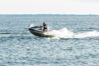 Sahilde güneşli bir günde şahsi su sanatı ve deniz ürünleri eğleniyor.