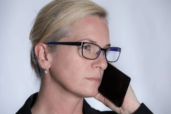woman listening to cell phone does not trust what is said