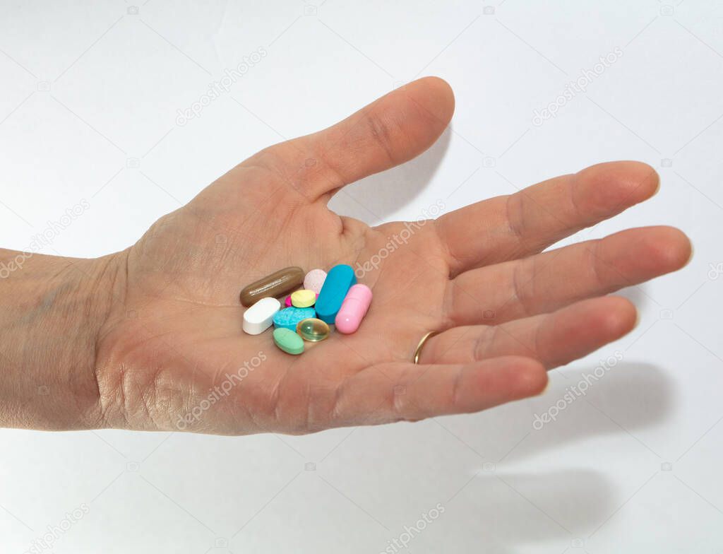 hand holding pills and tablets