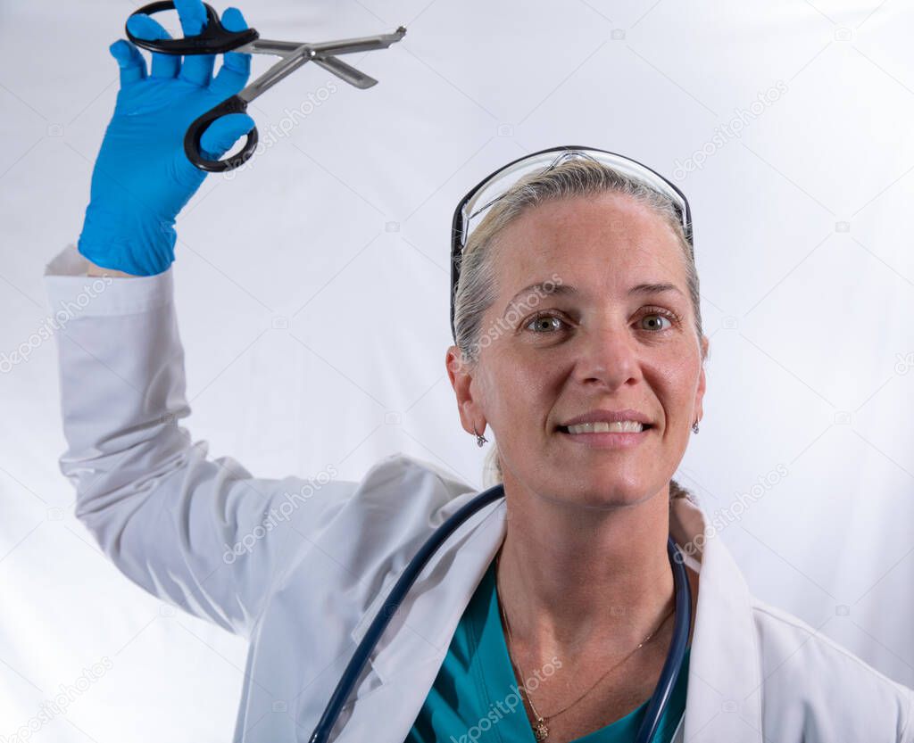 female doctor is happy to use her new scissors to cut something 
