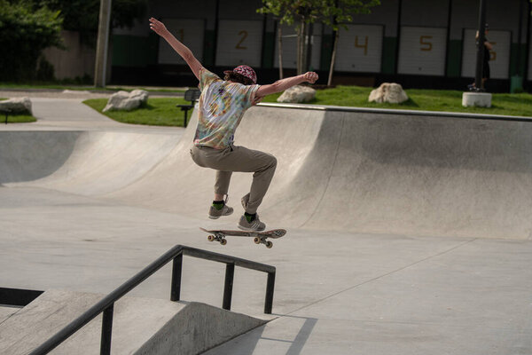 Detroit, Michigan, USA - 07.05.2019: skaters practice their skateboard tricks on a sunny day at the skate park.