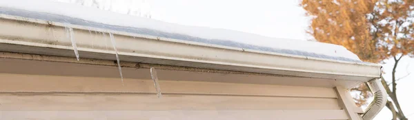 gutters are frozen and created an ice dam on your sloped roof