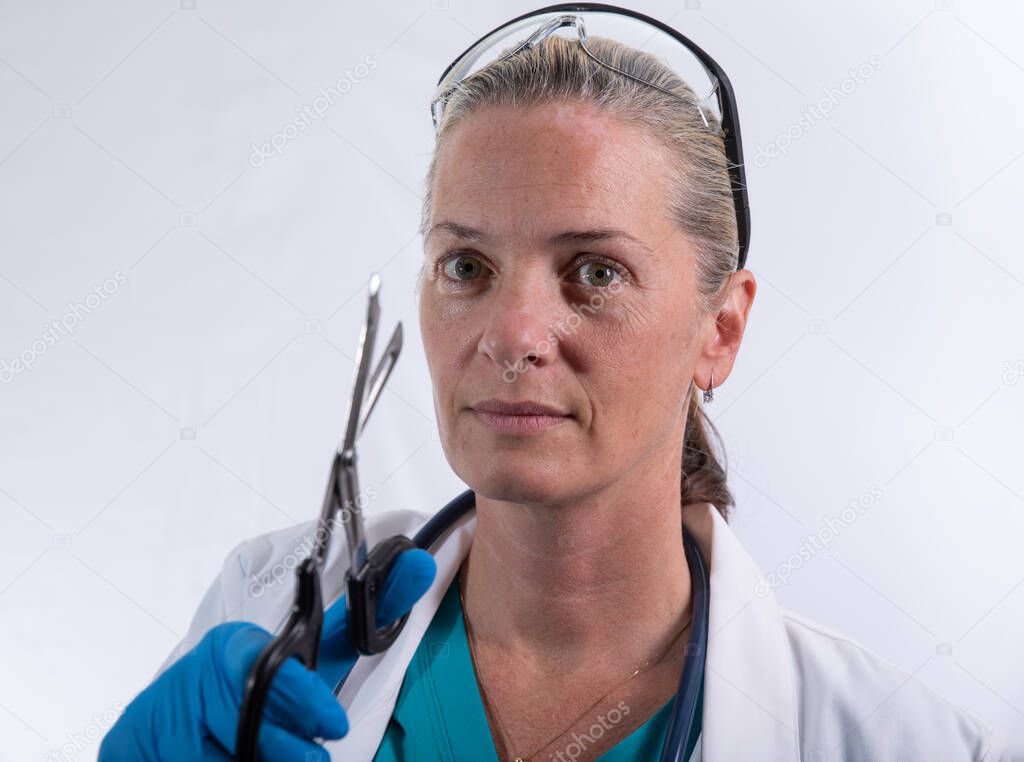 doctor is happy to use the scissors and cut something 