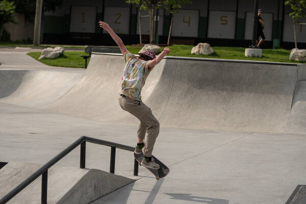 Detroit, Michigan, USA - 07.05.2019: skaters practice their skateboard tricks on a sunny day at the skate park.