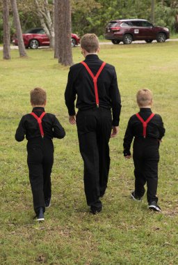 unknown brothers walking away from the wedding clipart