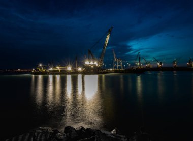 Vinçler gece limanda. Körfez köprüsünün manzarası