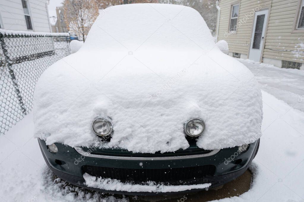 car is burried under a heavy snow fall