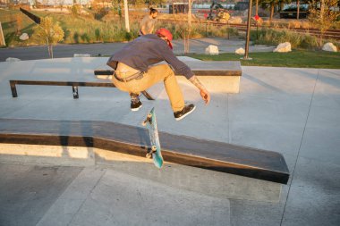 Detroit, Michigan, ABD - 10.20.2019: Patenciler ve motorcular Detroit kaykay parkında gün batımında numara yapıyor.