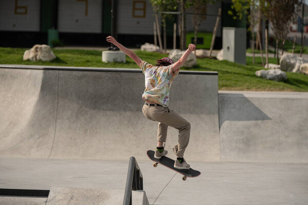 Detroit, Michigan, USA - 07.05.2019: skaters practice their skateboard tricks on a sunny day at the skate park.