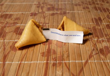 Tahta kahverengi tabakta, siyah üzerine izole edilmiş gevrek ve şekerli fal kurabiyeleri.