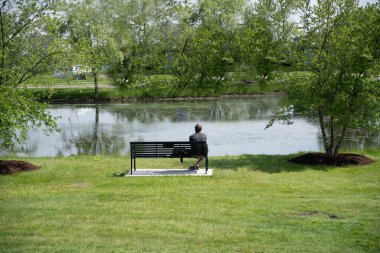 Bilinmeyen bir adam parkta tek başına oturmuş hayatını düşünüyor. 