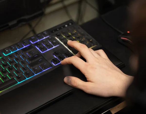 gamer works on his computer keyboard