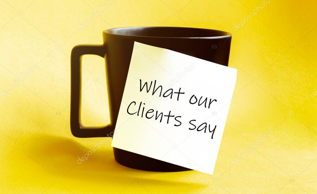 white paper with text What our Clients say on the black cup