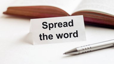 Metni olan bir kağıt parçası beyaz bir arkaplan üzerinde kitap, kalem arkaplan üzerine kelime yayın