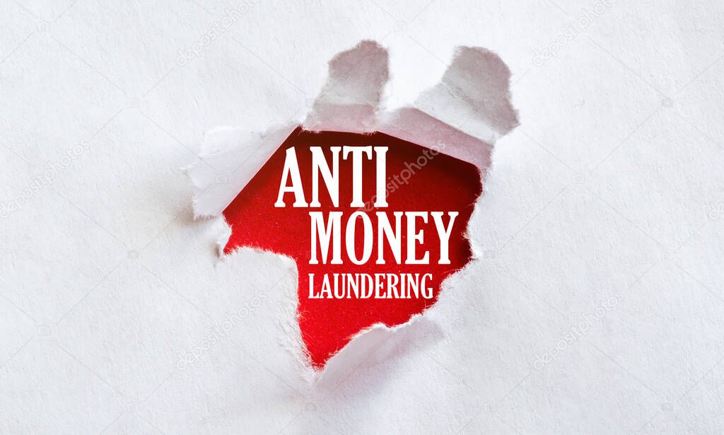 white torn paper with text Anti Money Laundering on red background