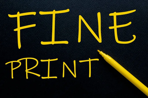 FINE PRINT Yellow Pen with yellow text own rent at the black background