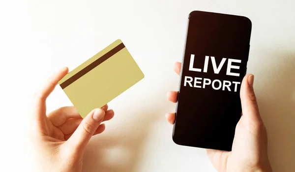 gold card and phone with text disaster recover plan Live Report in the female hands