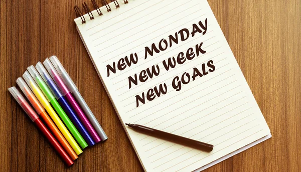 New Monday New Week New Goals. your future target searching, a marker, pen, three colored pencils and a notebook for writing