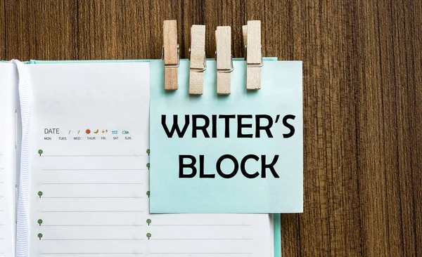 Writer S Block notes paper and a clothes pegs on wooden background