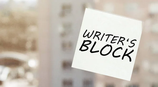 white paper with text Writer S Block on the window