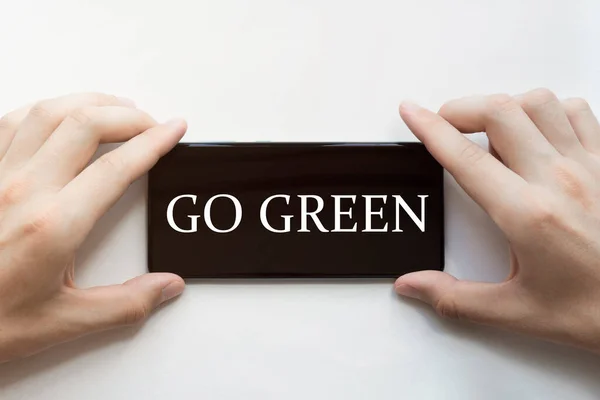 Male Hands Holding Black Phone Text Green White Background — Stock Photo, Image