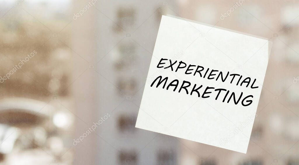 white paper with text Experiential Marketing on the window