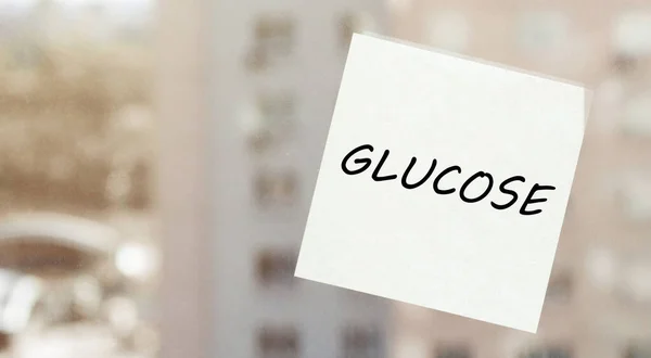 white paper with text GLUCOSE on the window