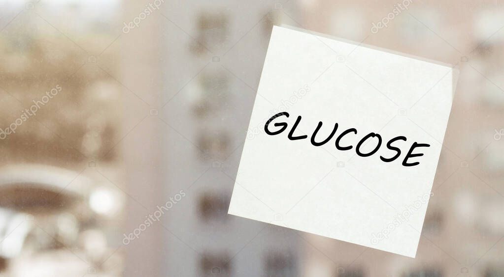 white paper with text GLUCOSE on the window