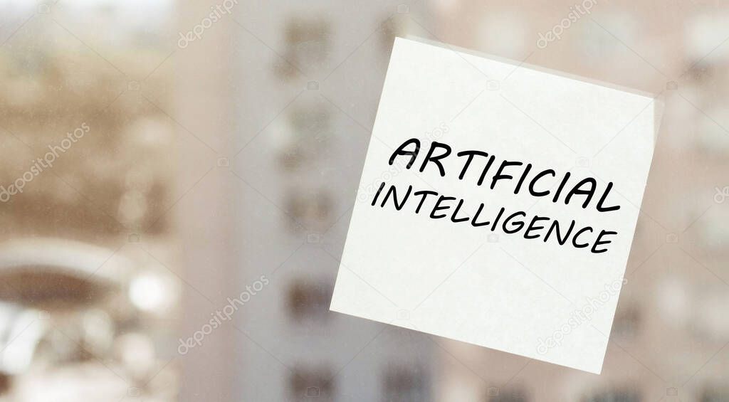 white paper with text Artificial intelligence on the window