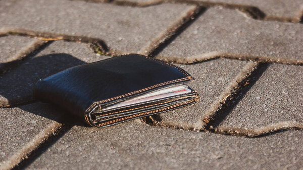 Wallet with all documents and money lying on ground