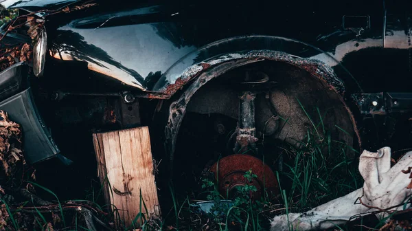 Abandoned car, rusty brake disc, car in scrap-heap