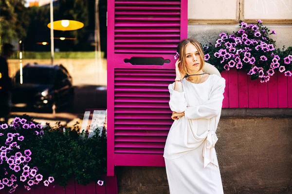 漂亮的女人在白色复古礼服的街道上 紫色的窗户背后 — 图库照片
