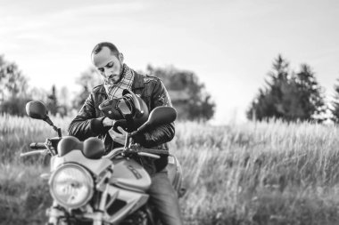 Kask spor motosiklet yolda açık otururken elinde tutan motorcu