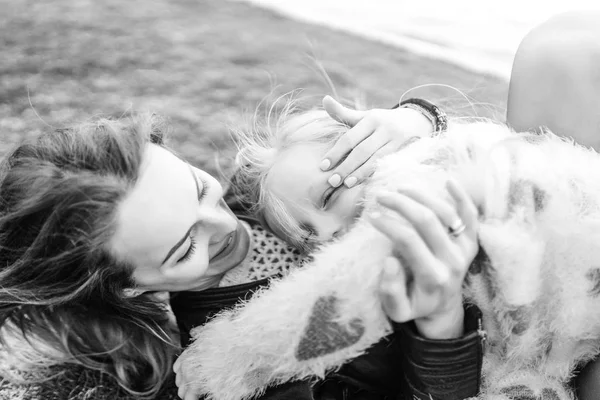 Mãe Com Pequena Filha Divertindo Abraçando Enquanto Deitado Grama Livre — Fotografia de Stock
