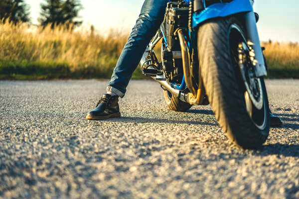 Biker on sport motorcycle on asphalt road