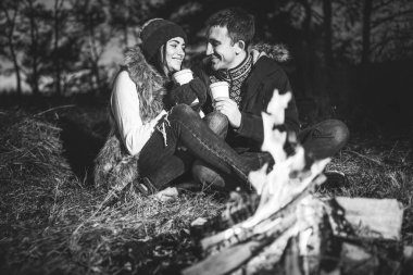 Şenlik ateşi yakınındaki ormanda sıcak içecek içme oldukça genç çift