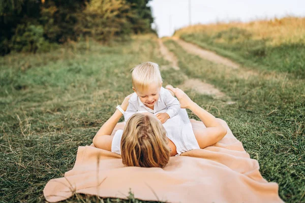 Young Mother Little Son Having Fun While Lying Coverlet Meadow — Stock Photo, Image