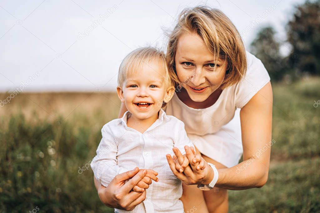 Mother with little son having fun outdoor