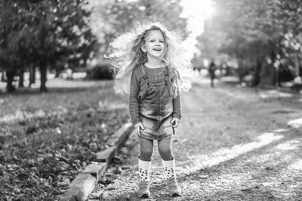 Śliczną Dziewczynkę Kręcone Fryzury Noszenie Ubrania Dorywczo Zabawy Parku Jesień — Zdjęcie stockowe