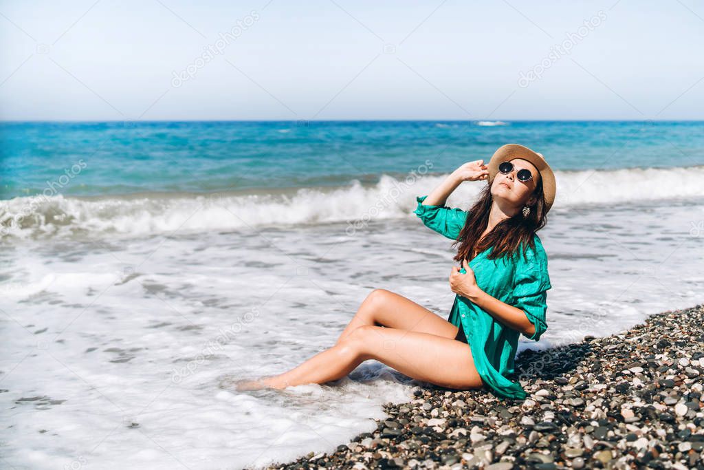 Pretty pan asian travel girl relaxing on the beach at the sea in