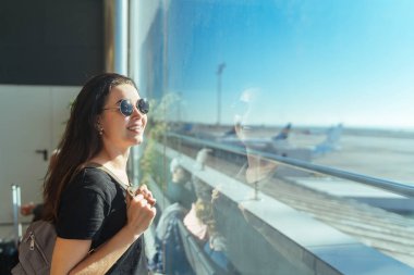 Kalkış havaalanında bekleyen esmer uzun saçlı kız