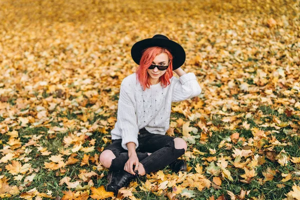 公園でリラックスした赤い髪と帽子を持つかわいい女の子、秋のt — ストック写真