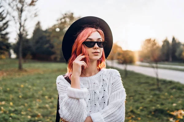 Chica bonita con el pelo rojo y sombrero relajante en el parque, t otoño — Foto de Stock