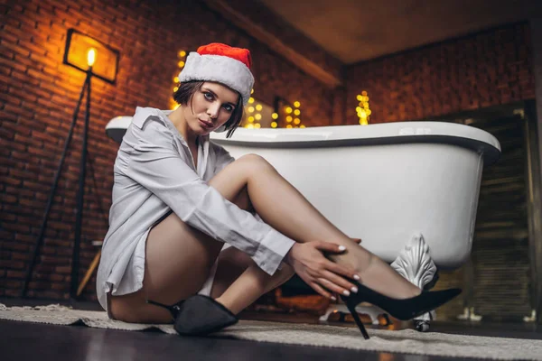Μια Νεαρή Μελαχρινή Ποζάρει Στο Πάτωμα Κοντά Στο Μπάνιο Χριστουγεννιάτικο — Φωτογραφία Αρχείου