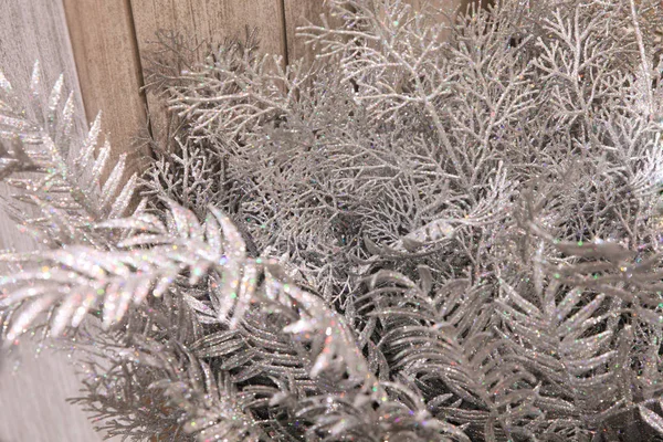 Abstract shimmering background of silver decorative branches with bokeh effect